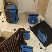 Emergency cleanup technicians setting containment and extraction hoses